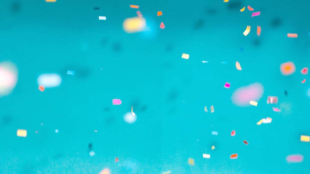 colorful confetti on turquoise background