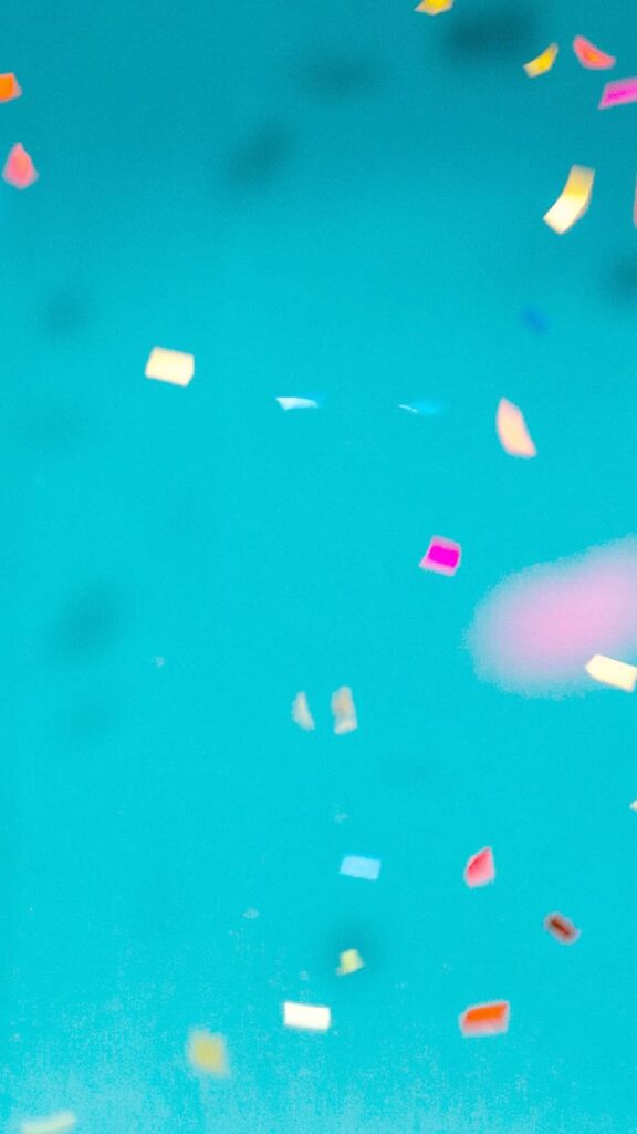 colorful confetti on turquoise background