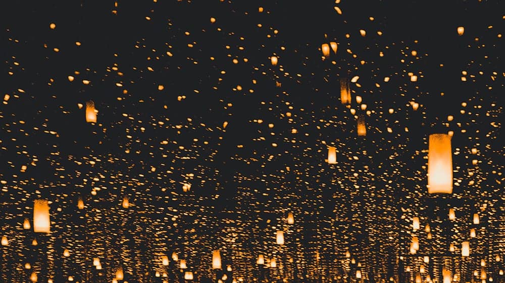 thousands of orange lanterns on dark background