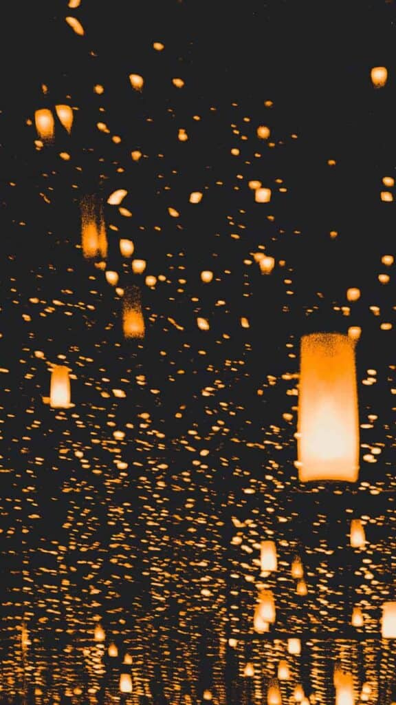 thousands of orange lanterns on dark background