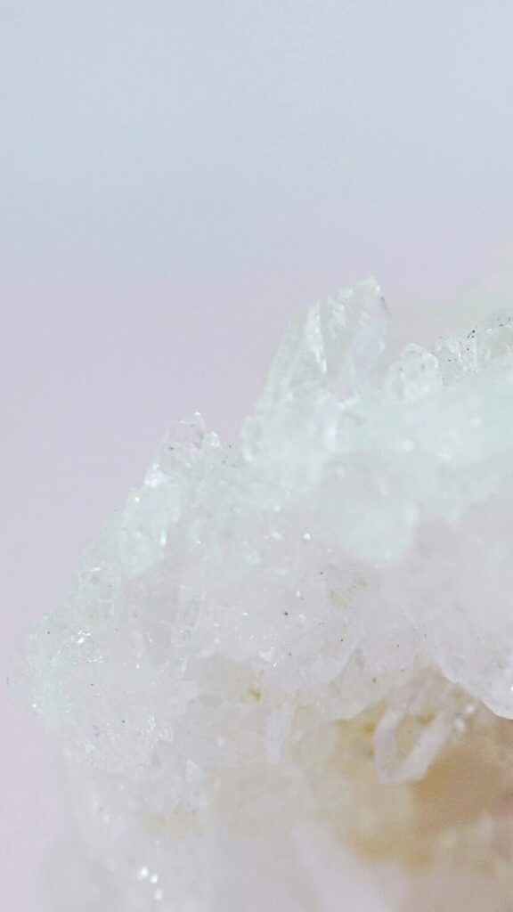 white quartz crystal on light pink background