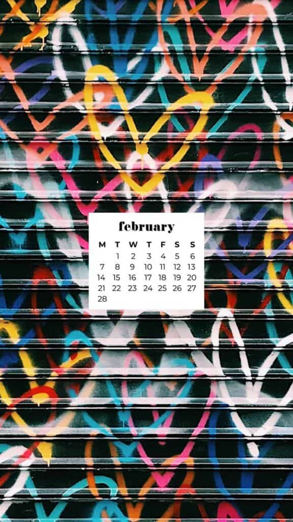 graffiti spray painted colorful hearts on a black metal wall - February 2022 wallpapers – 50 FREE calendars for your desktop & phone!