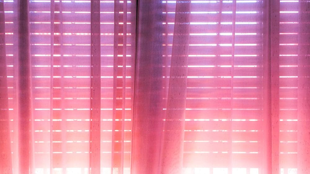 pink, coral and white ombre curtains with light coming through