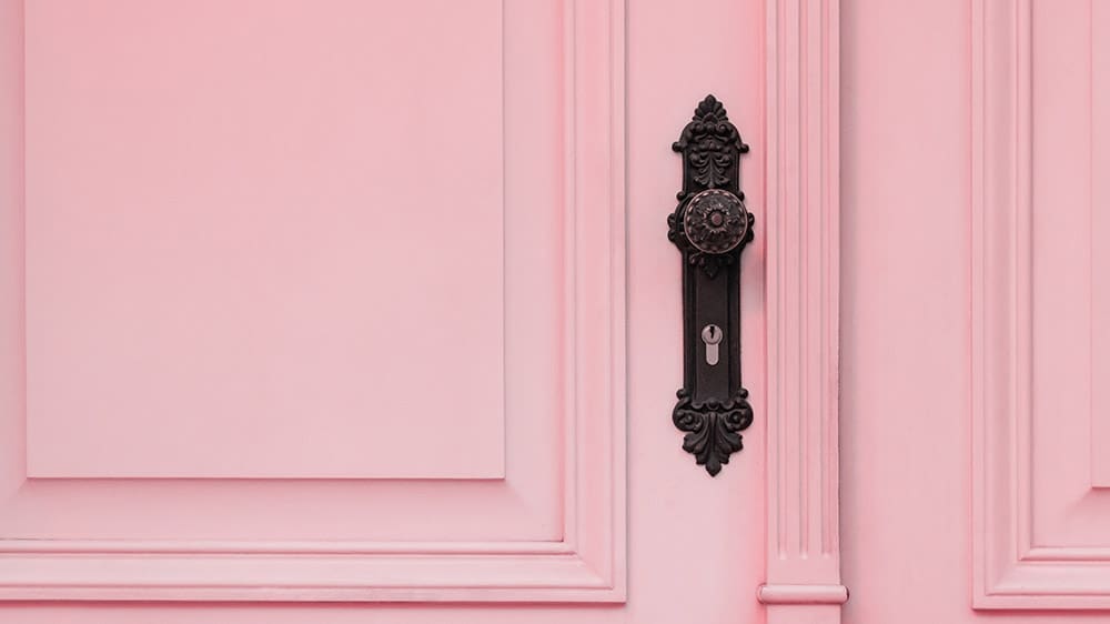 pretty detailed pink exterior front door with cool, old door knob