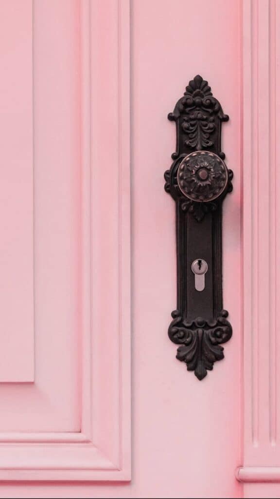 pretty detailed pink exterior front door with cool, old door knob