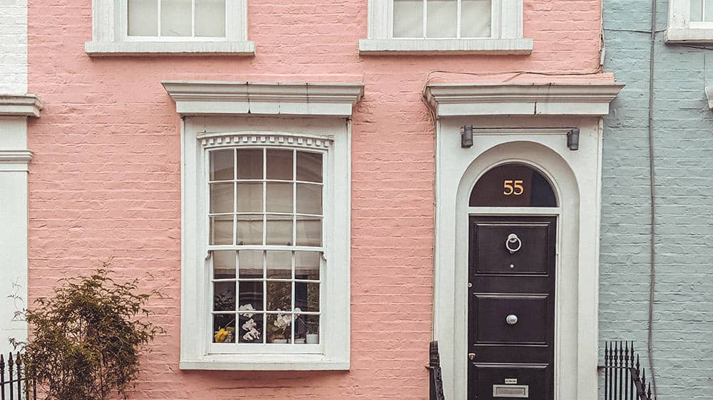 pretty pink painted brownstone flat with cool old black door