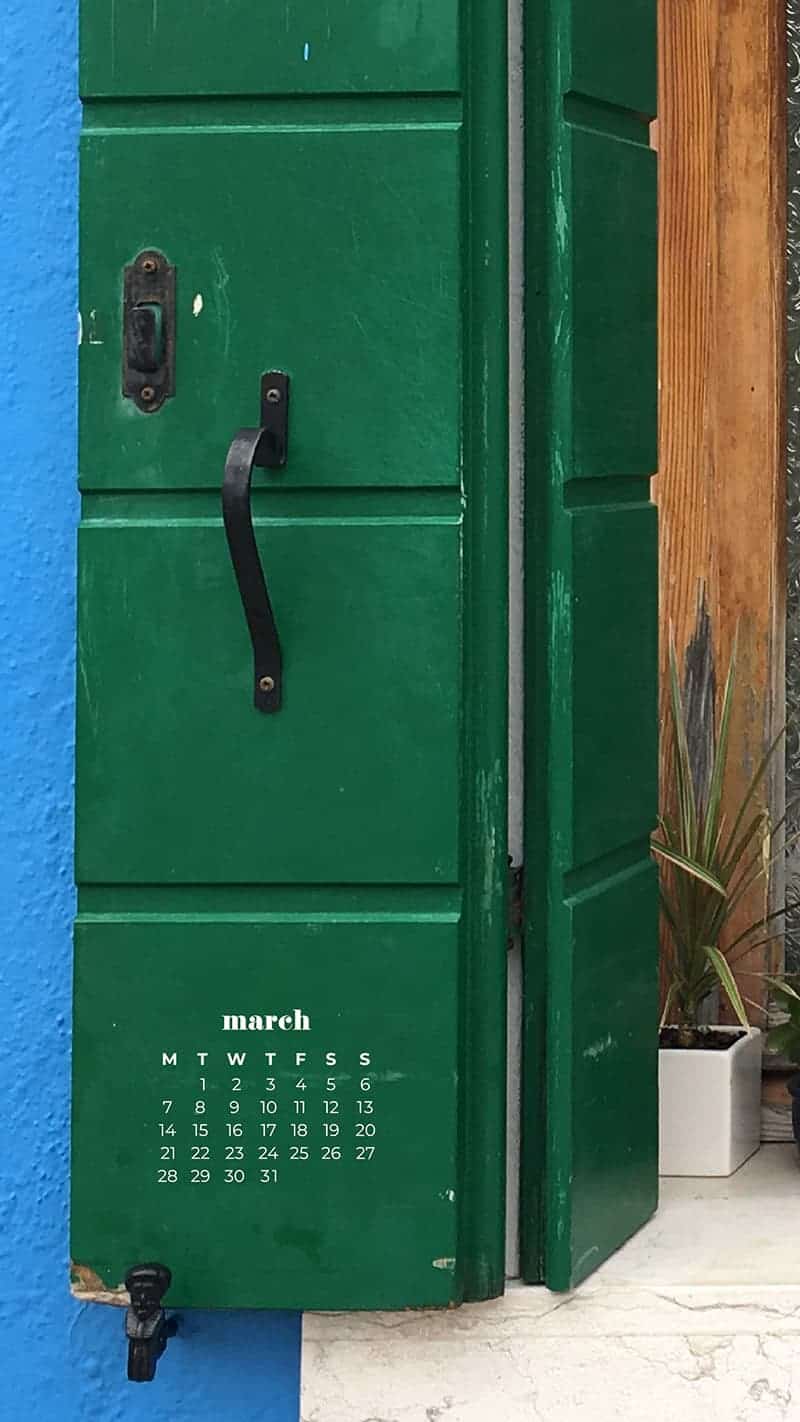 blue building with green shutters and potted plants- March 2022 free desktop wallpaper