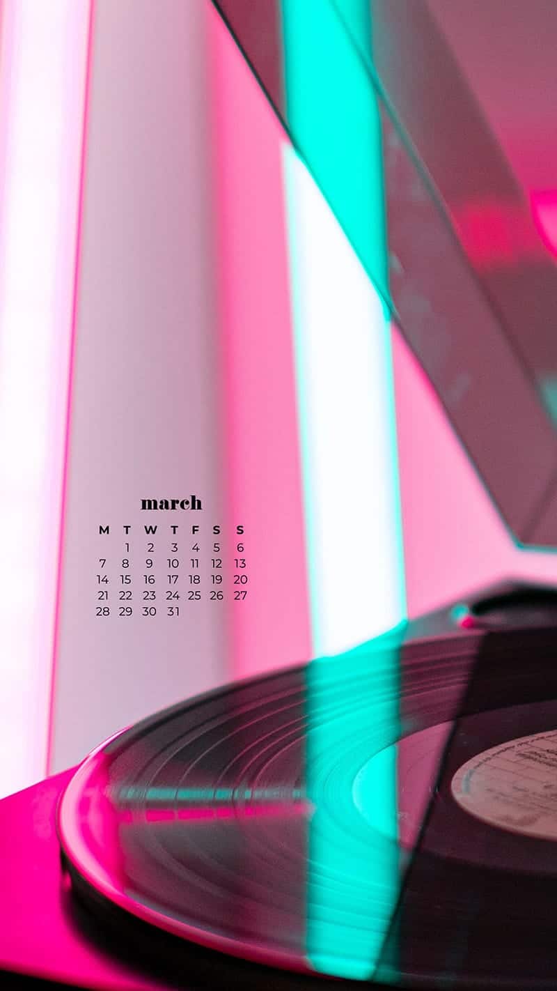 record player turntable with a record and pink and turquoise neon reflections - March 2022 free desktop wallpaper