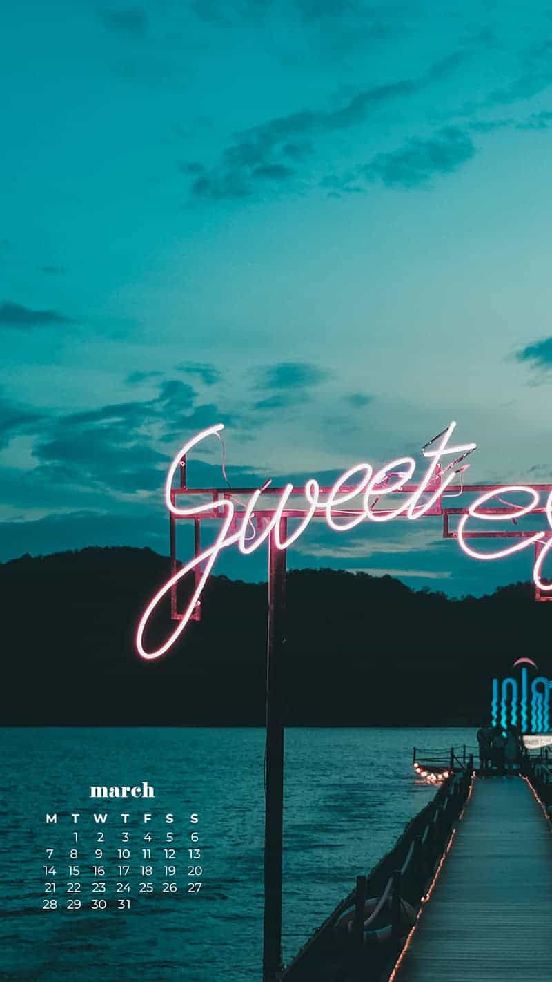 sweet escape neon sign on a dock in tahiti - March 2022 free desktop wallpaper