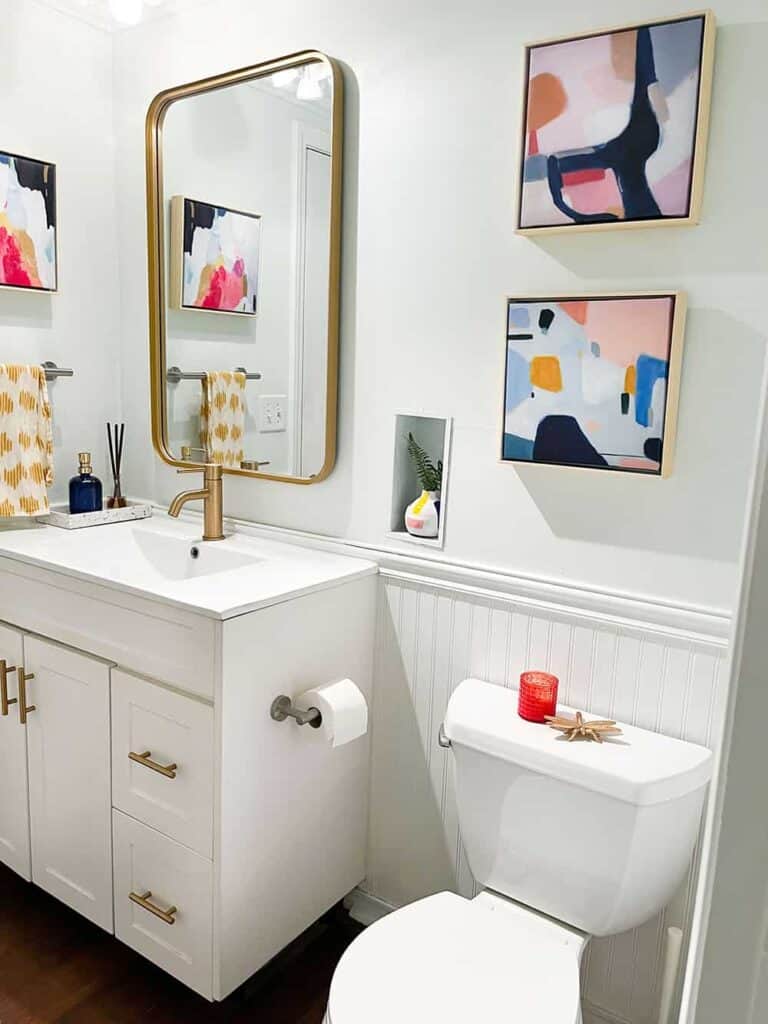 coordinating colorful and modern half bathroom connected to laundry room