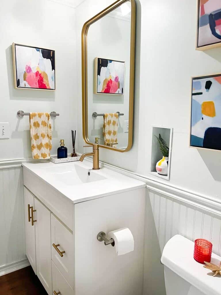 coordinating colorful and modern half bath connected to laundry room