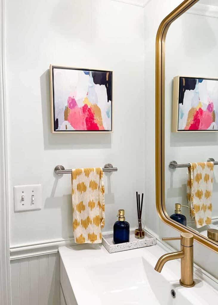 coordinating colorful and modern half bathroom connected to laundry room