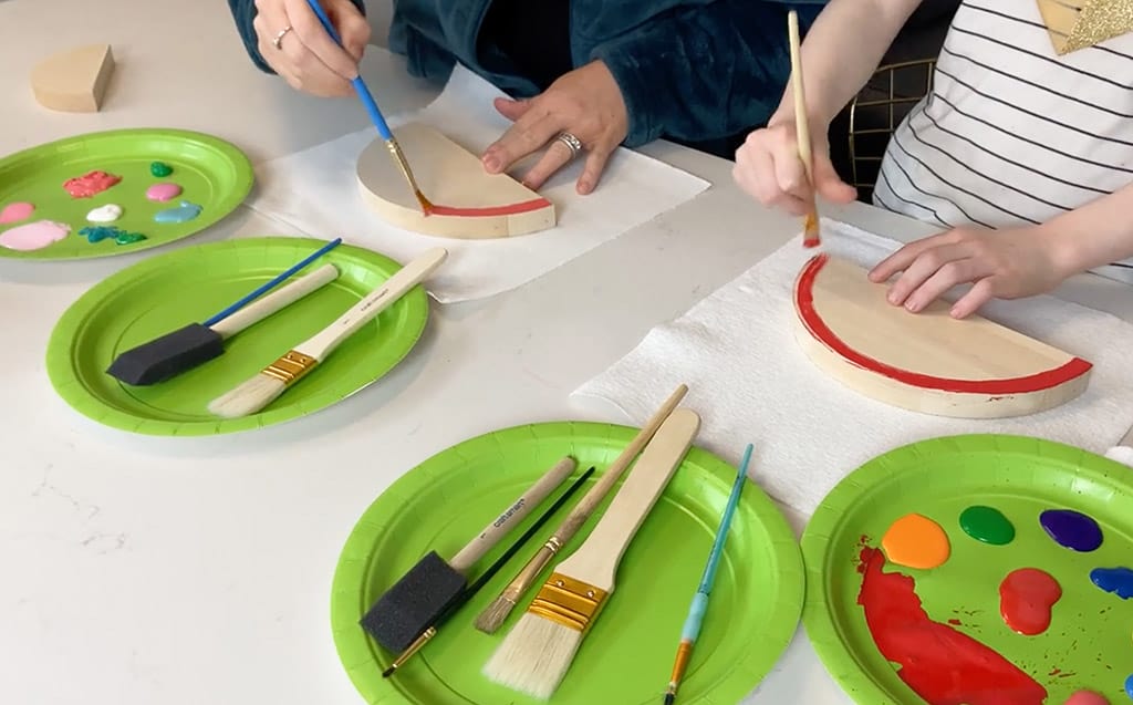 Rainbow wood slice and pom pom lamp – Colorful, fun, and easy DIY decor ideas for a kid's room or birthday party activity!