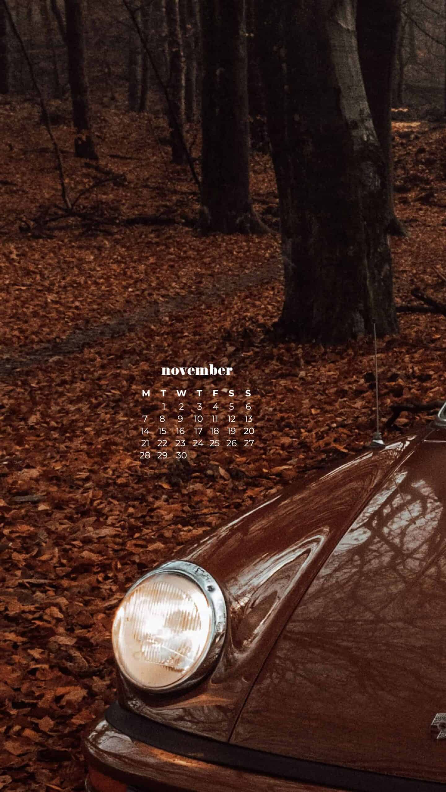 vintage rust colored porche car in a forest with matching colored leaves on ground - monochromatic autumn fall shot November 2022 wallpapers – FREE calendars in Sunday & Monday starts + no-calendar designs. 59 beautiful options for desktop & smart phones!