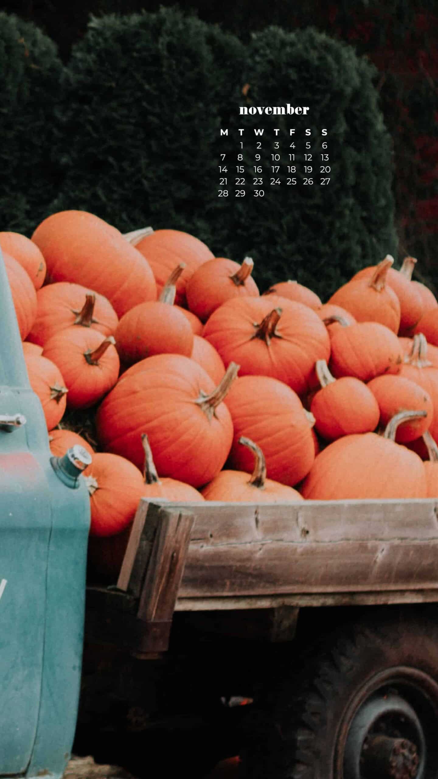 aqua vintage truck with orange pumpkins in the back and on the ground by a red barn fall scene November 2022 wallpapers – FREE calendars in Sunday & Monday starts + no-calendar designs. 59 beautiful options for desktop & smart phones!