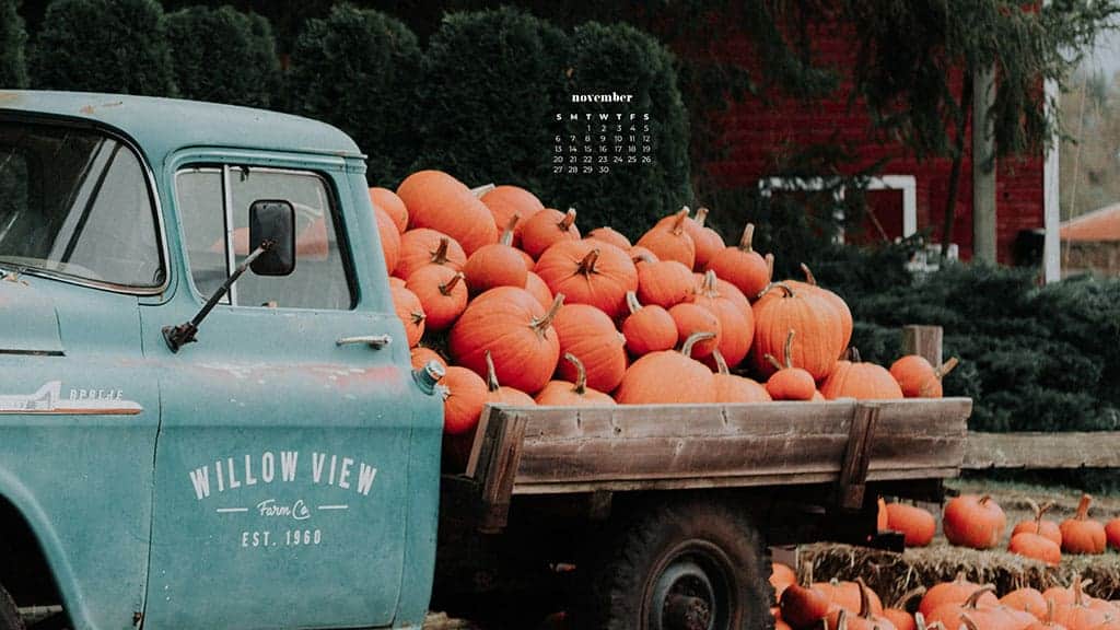 aqua vintage truck with orange pumpkins in the back and on the ground by a red barn fall scene November 2022 wallpapers – FREE calendars in Sunday & Monday starts + no-calendar designs. 59 beautiful options for desktop & smart phones!