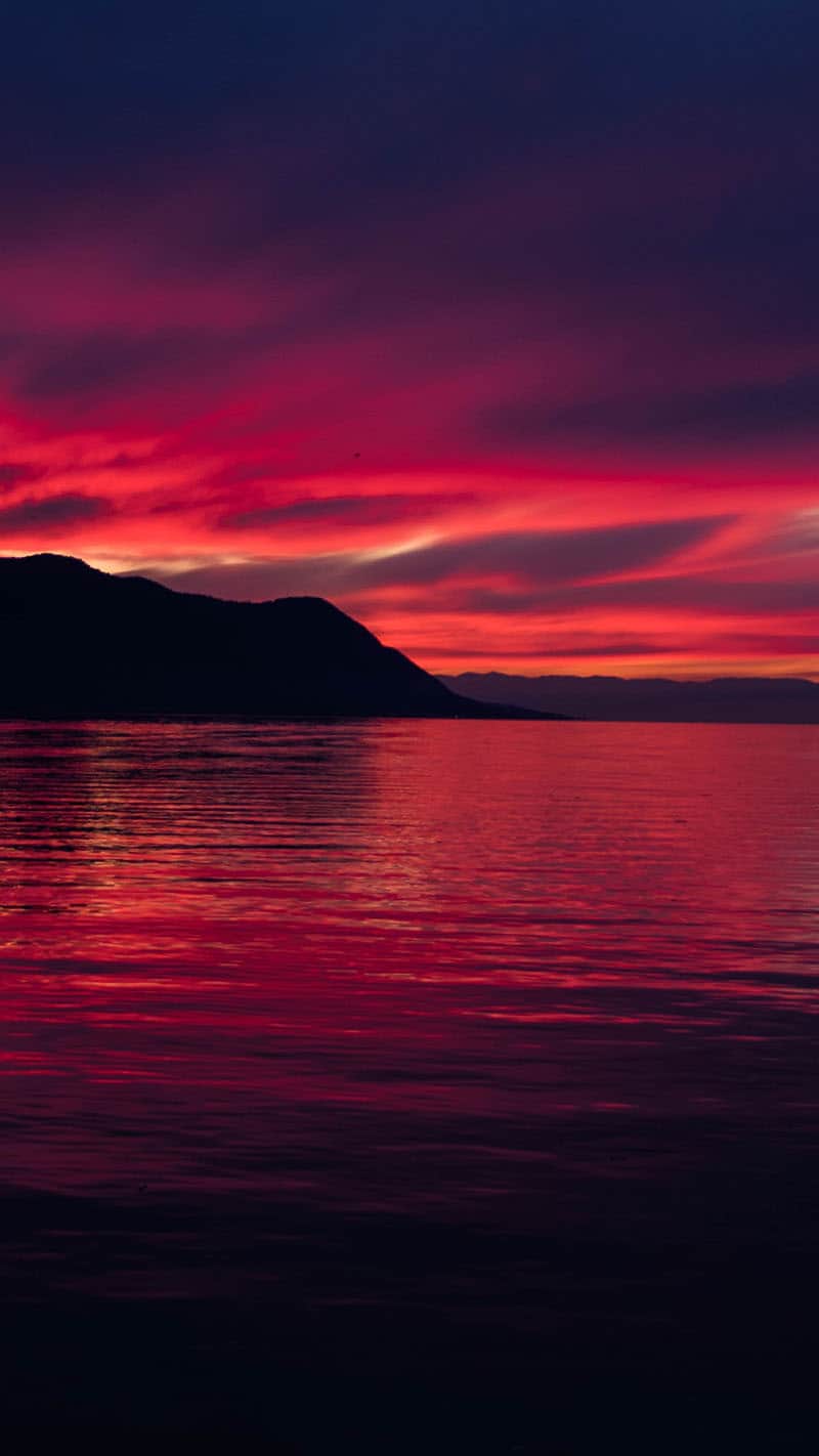 lake with a pink and purple sunset