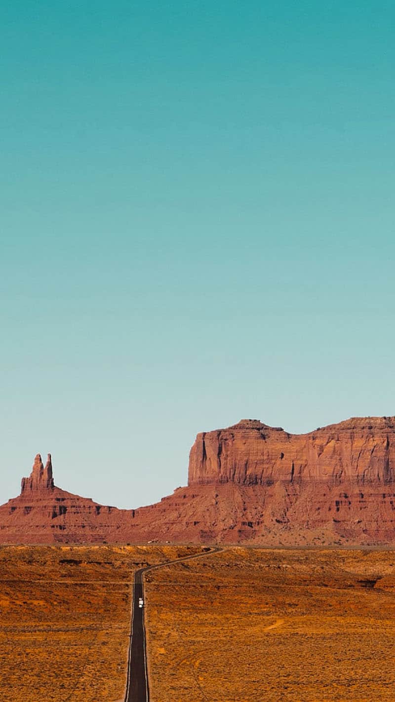 desert mesas and cliffs against aqua sky 