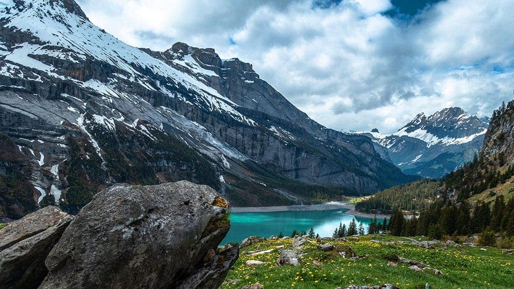 turquoise lake in front of a beautiful snow capped mountain