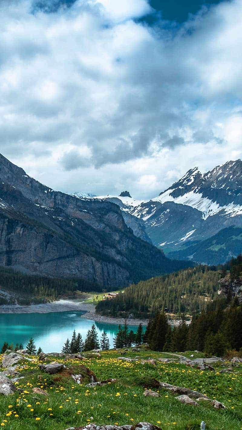 turquoise lake in front of a beautiful snow capped mountain