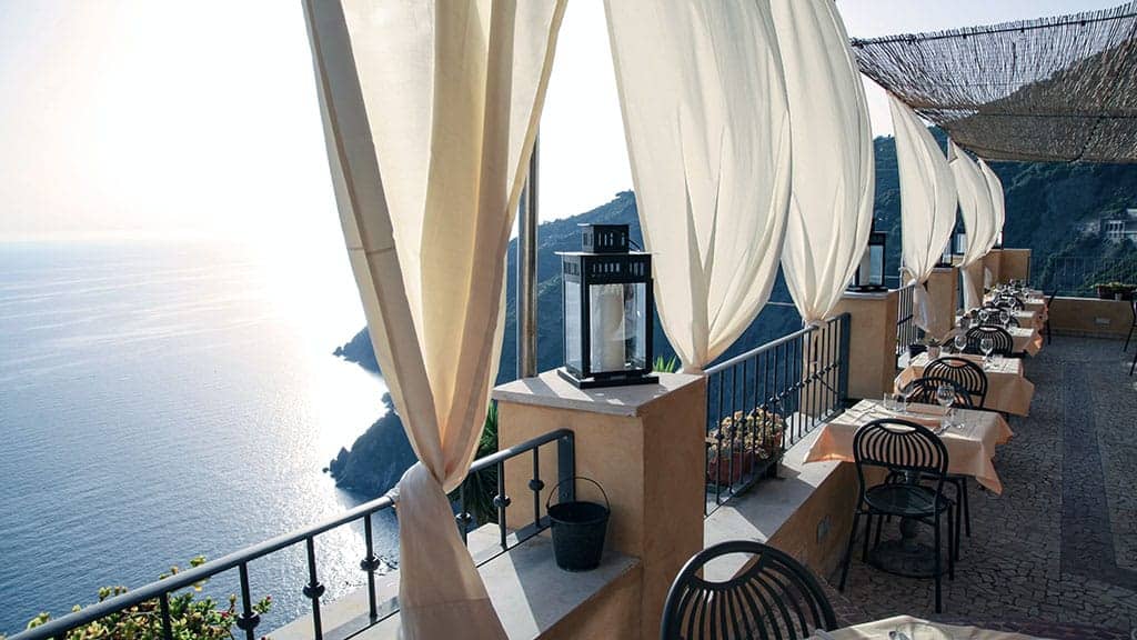 cafe outside on the sea with white curtains 