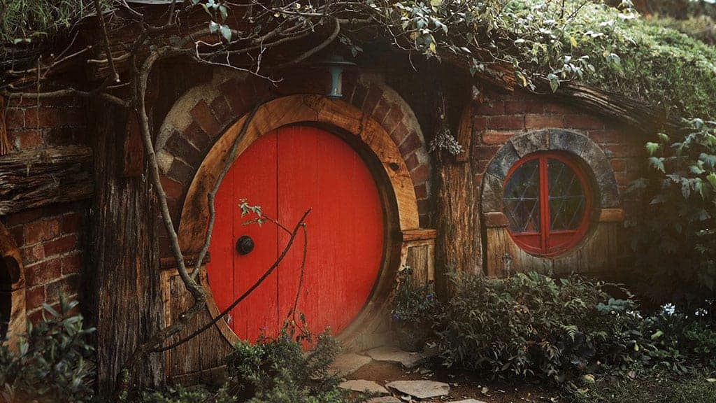 colorful hobbit house with red front door