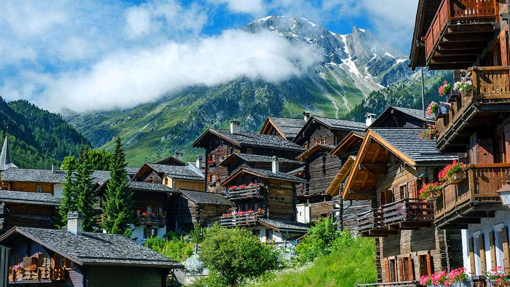 chalets in switzerland with mountains behind