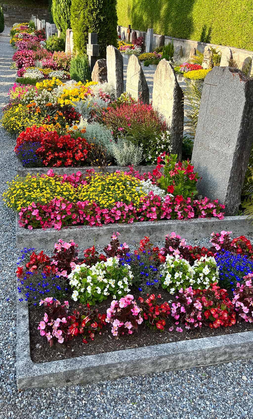 Beautiful graveyard in Grindelwald with colorful flowers everywhere Grindelwald Switzerland is a stunning destination right out of a fairytale! I'm breaking down all the details for our 3 night visit.