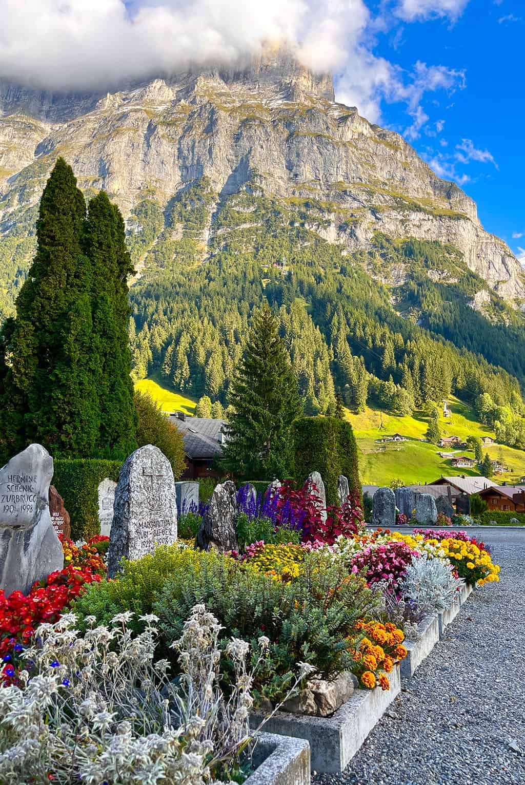 Beautiful graveyard in Grindelwald with colorful flowers everywhere Grindelwald Switzerland is a stunning destination right out of a fairytale! I'm breaking down all the details for our 3 night visit.