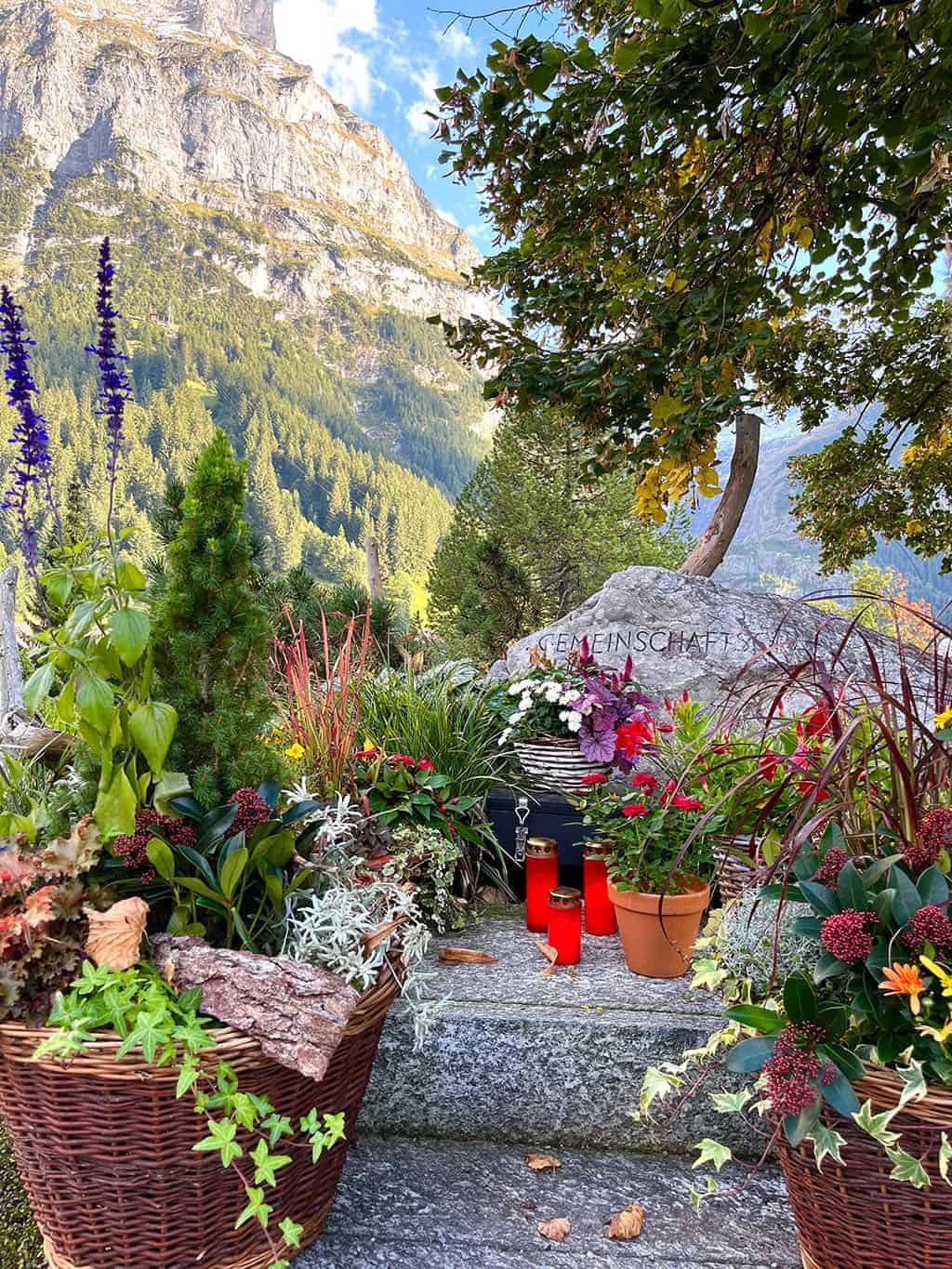 Beautiful graveyard in Grindelwald with colorful flowers everywhere Grindelwald Switzerland is a stunning destination right out of a fairytale! I'm breaking down all the details for our 3 night visit.