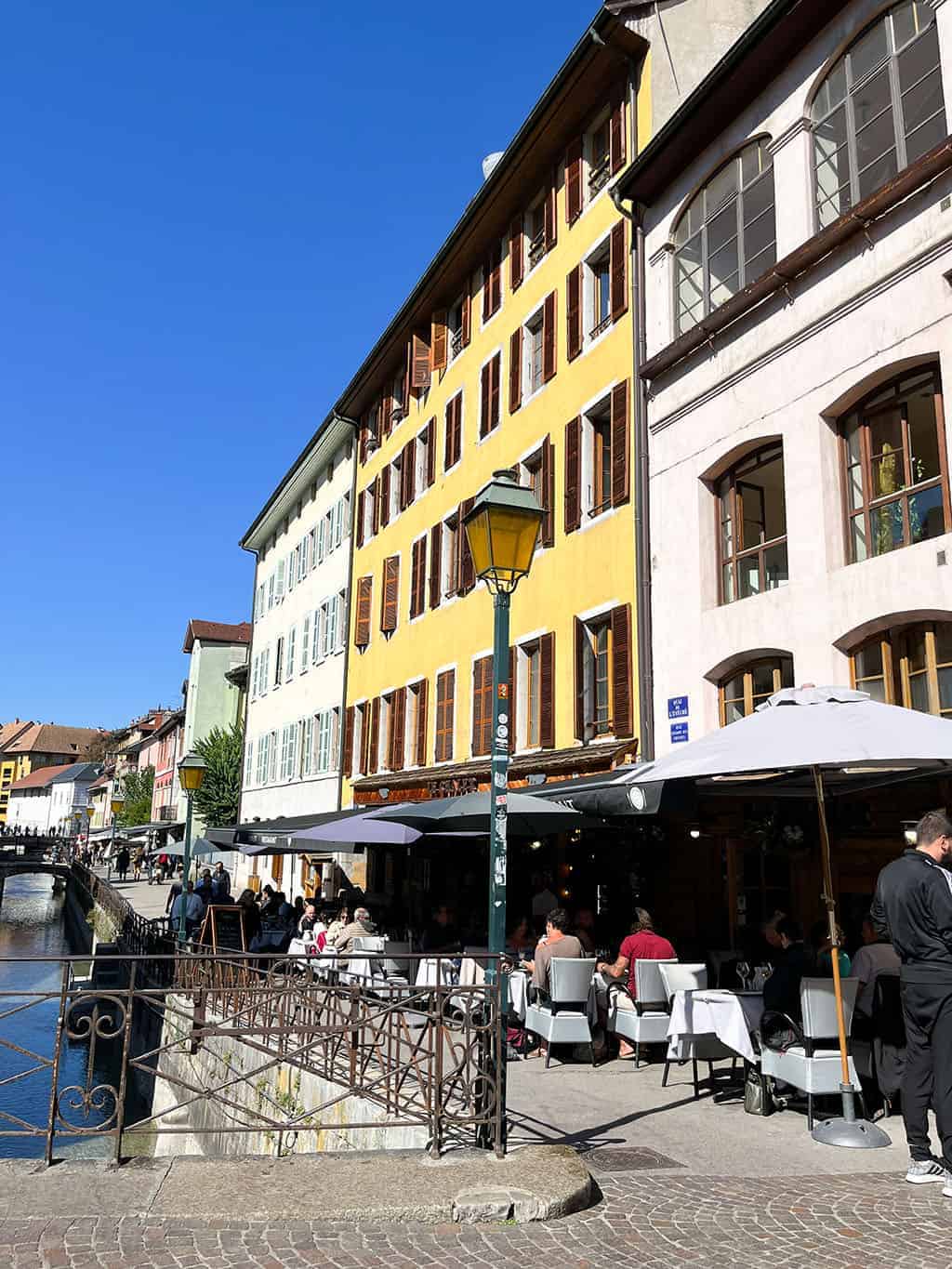 Day trip to Annecy France - Cobblestone streets, colorful architecture, and a stunning crystal blue lake.