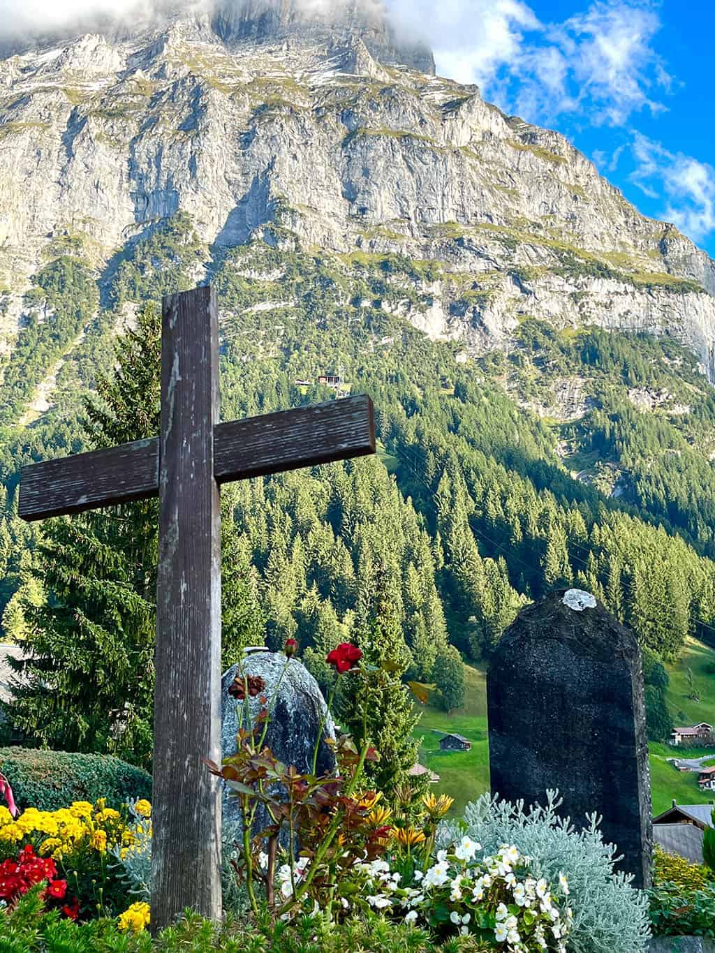 Beautiful graveyard in Grindelwald with colorful flowers everywhere Grindelwald Switzerland is a stunning destination right out of a fairytale! I'm breaking down all the details for our 3 night visit.